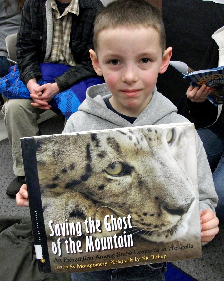 student holding Snow Leopard book