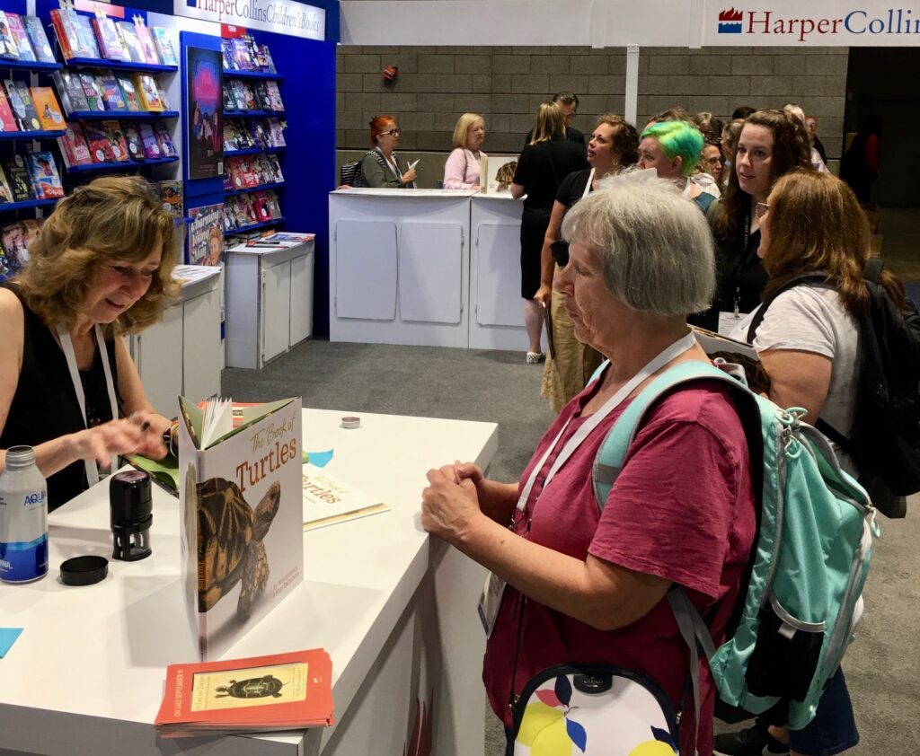 Sy signs turtle books for a long line of fans at the American Library Association (ALA) convention in Chicago.