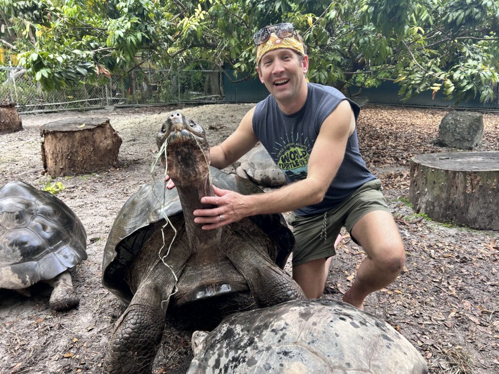 Matt meets a Galapagos tortoise at a turtle sanctuary.