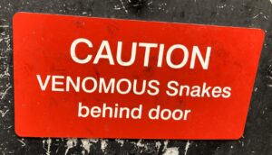 Sign: Venomous snakes behind the door